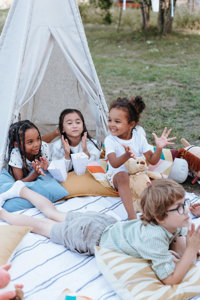 pexels photo 10045492 10045492 Group of diverse children playing cheerfully in a backyard teepee setup, enjoying outdoor leisure.